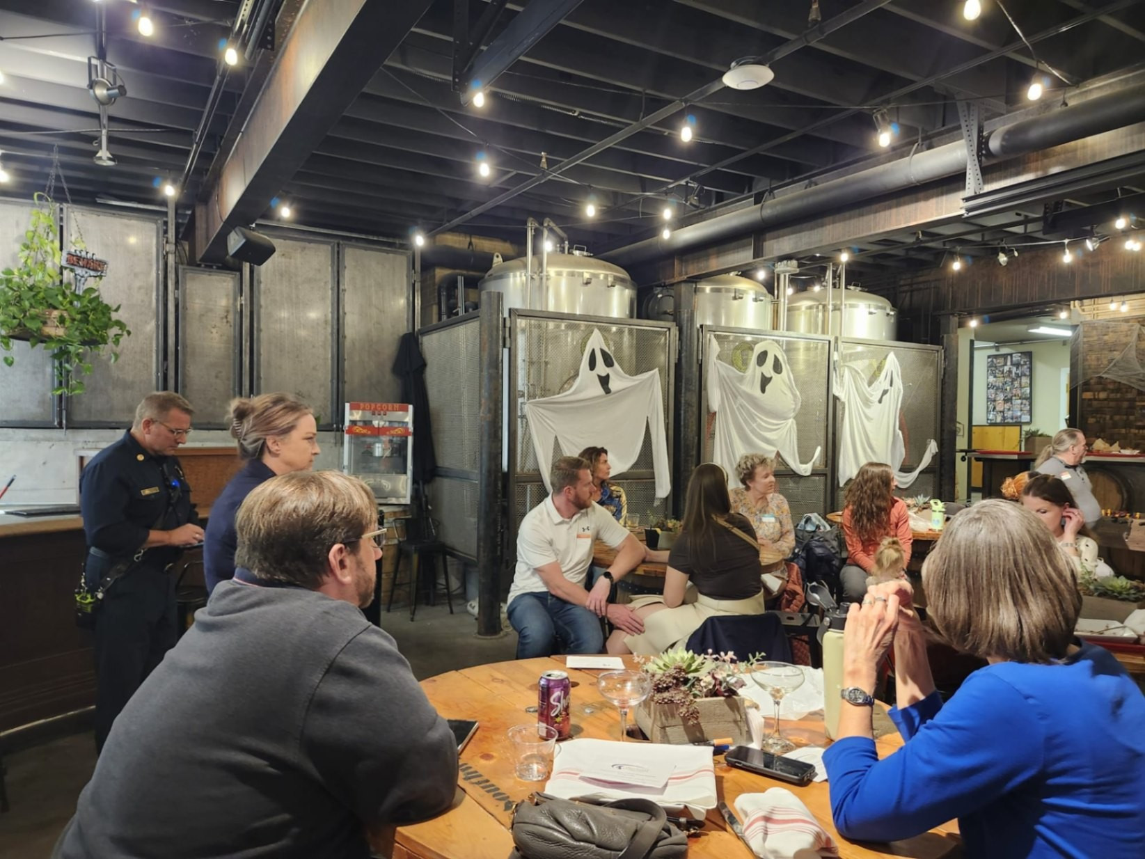 Members listening to nonprofit pitch at the brewery